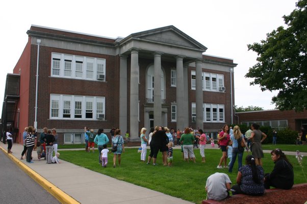 Parents gather outside the recently renovated Hampton Bays Elementary School at about 3 p.m. on September 9, the first day of school. KYLE CAMPBELL