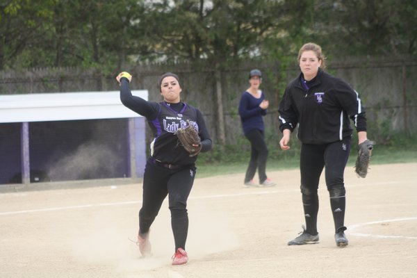 Hampton Bays pitcher Marley Tyler throws to first for an out in her team's 4-3 win over Miller Place in the first round of the Class A playoffs. CAILIN RILEY