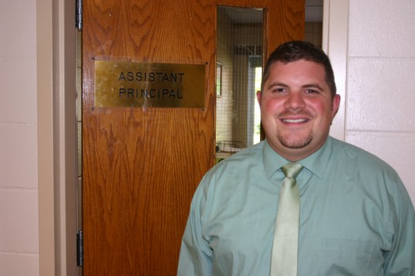 Eric Ferraro, Hampton Bay High School's most recent addition to its administrative staff, stands in front of his new office on September 25. KYLE CAMPBELL