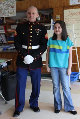 Marine Corporal Jacob Campbell with Jocelyn McNamara, 10,  at the East Quogue Elementary School on Wednesday, April 24. By Carol Moran