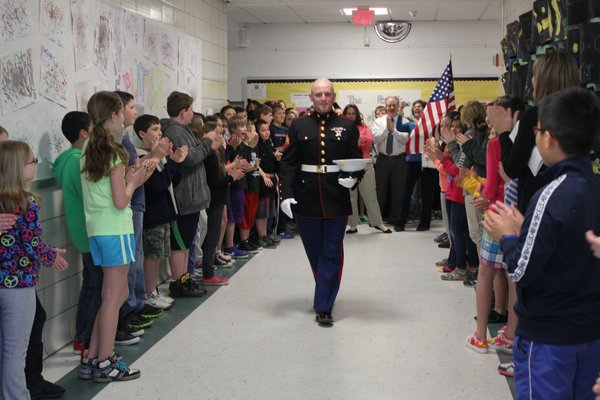 East Quogue Elementary School students greet Marine Corporal Jacob Campbell, who visited on Wednesday, April 24. By Carol Moran