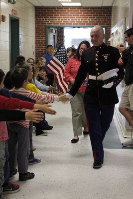 East Quogue Elementary School students greet Marine Corporal Jacob Campbell, who visited on Wednesday, April 24. Carol Moran By Carol Moran