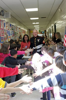 East Quogue Elementary School students greet Marine Corporal Jacob Campbell, who visited on Wednesday, April 24. By Carol Moran