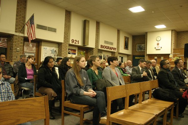 Parents and students sit in the Hampton Bays High School Library during the school board of education's monthly meeting Tuesday night. KYLE CAMPBELL