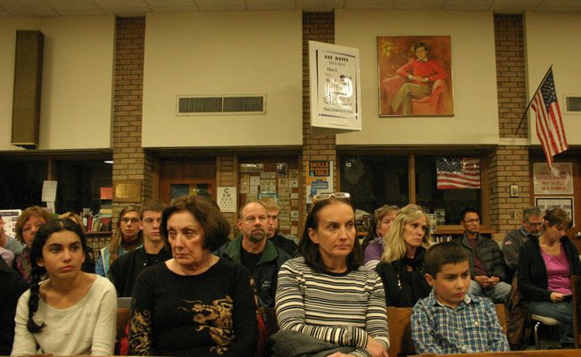 Parents and students sit in the Hampton Bays High School Library during the school board of education's monthly meeting Tuesday night. KYLE CAMPBELL