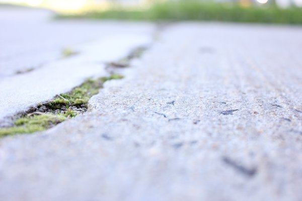 Cracks in concrete along thte walkway to the school will be repaired following the approval of the $8.7 million renovation. VALERIE GORDON