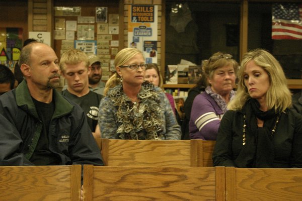 Liz Catz, center, addresses the the Hampton Bays Board of Education during the board's monthly meeting Tuesday night. Ms. Catz, the mother of a senior on the high school's varsity football team, was upset with how the school handled a recent incident with the team that resulted in the forfeit of its final game. KYLE CAMPBELL