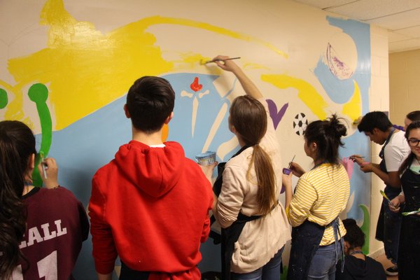 Hampton Bays art students paint the mural. COURTESY KEEGAN BISHOP