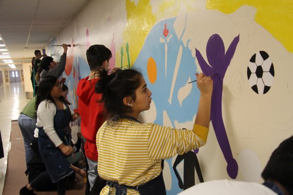 Hampton Bays art students pain the mural. COURTESY KEEGAN BISHOP