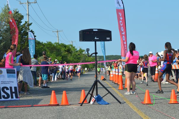 Just prior to the first finisher coming in, a big inflatable marking the finish line died out. Theresa Roden was able to pull out some pink ribbon though to mark the finish line. KIM COVELL