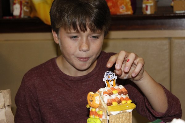 Kellen Stewart makes a gingerbread house. VALERIE GORDON