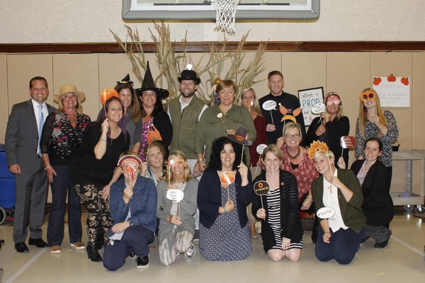 The teachers involved with the craft fair take a silly picture at the photo booth station. VALERIE GORDON