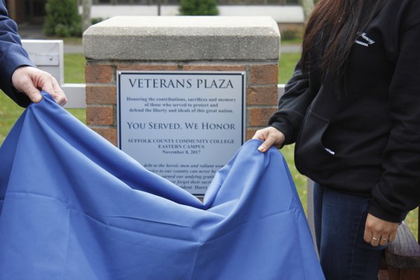 The space behind the Peconic Building is officially dedicated Veterans Plaza with the unveiling of the plaque. VALERIE GORDON