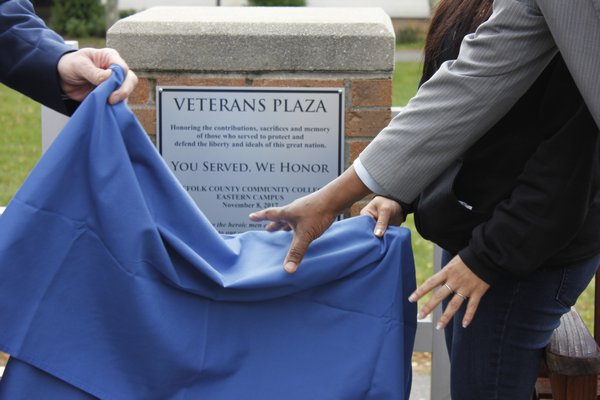 The space behind the Peconic Building is officially dedicated Veterans Plaza with the unveiling of the plaque. VALERIE GORDON