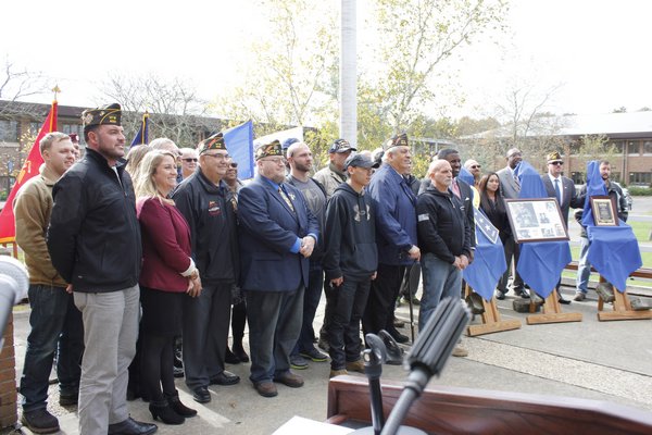 All of the veterans gather in front of the plaque for a group photo. VALERIE GORDON