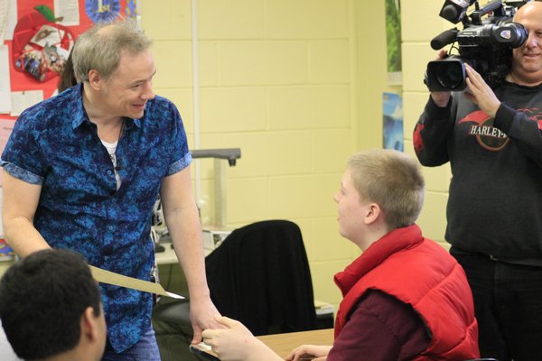 Jacob, a student at the Westhampton Beach Learning Center, gives a song he wrote to acclaimed children's musician Brady Rymer on Monday morning. KYLE CAMPBELL