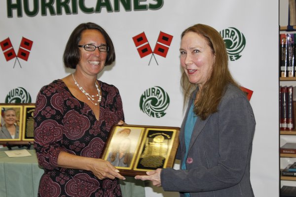 Westhampton Beach High School Board of Education President Suzanne Mensch honors Ms. Lynne Cuthbert Jones, one of the 2016-2017 Wall of Fame inductees. KATE RIGA