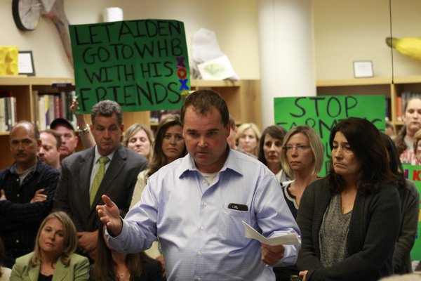 Remsenburg resident Christian Killoran speaks to the Westhampton Beach Board of Education on Monday night. Mr. Killoran, who was joined by roughly 40 supporters, urged the board to commit to creating a program for alternately assessed special needs students. KYLE CAMPBELL