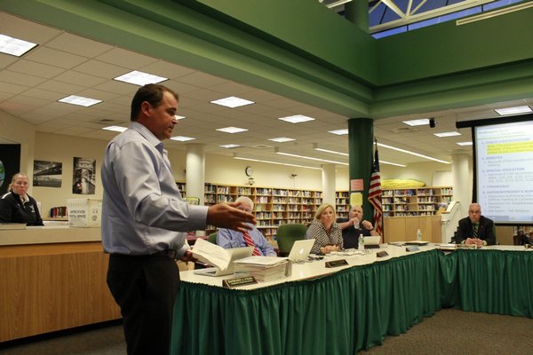 Remsenburg resident Christian Killoran speaks to the Westhampton Beach Board of Education on Monday night. Mr. Killoran, who was joined by roughly 40 supporters, urged the board to commit to creating a program for alternately assessed special needs students. KYLE CAMPBELL