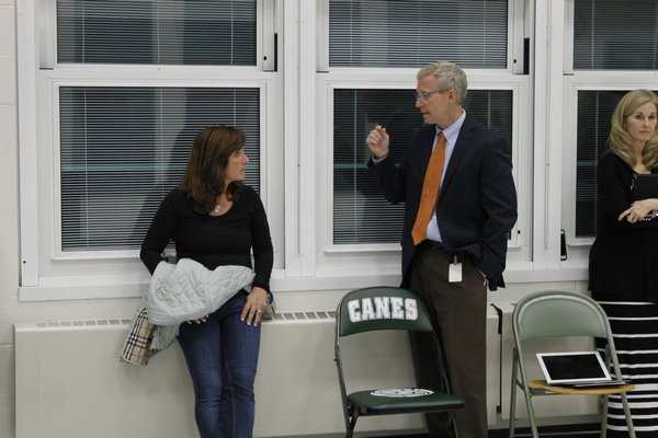 Westhampton Beach School Board candidate Stacy Rubio, left, talks to district assistant superintendent Willaim Fisher on Tuesday night KYLE CAMPBELL