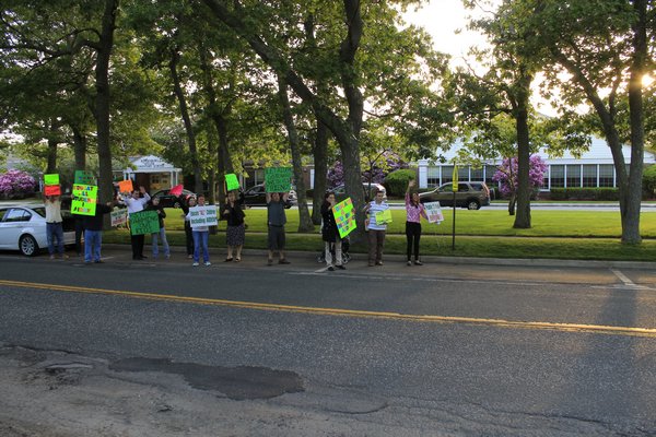 Christian and Terrie Killoran of Remsenburg orchestrated a protest outside the Remsenburg-Speonk Elementary School on Monday night prior to the school's board of education meeting. KYLE CAMPBELL