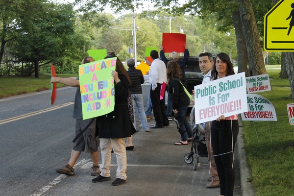 Christian and Terrie Killoran of Remsenburg orchestrated a protest outside the Remsenburg-Speonk Elementary School on Monday night prior to the school's board of education meeting. KYLE CAMPBELL