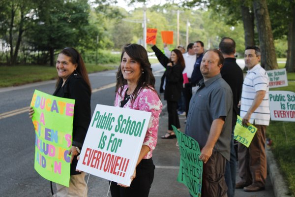 Christian and Terrie Killoran of Remsenburg orchestrated a protest outside the Remsenburg-Speonk Elementary School on Monday night prior to the school's board of education meeting. KYLE CAMPBELL