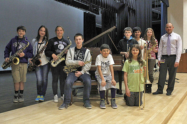 The Hampton Bays Middle School Jazz Band with the baby grand piano donated by Sally and Michael Pope. CAROL MORAN