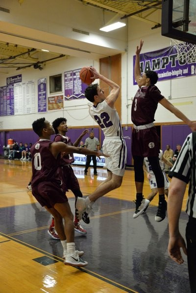 Hampton Bays senior Matt Dean tries to elude Southampton defenders as he drives to the basket. MICHELLE MALONE