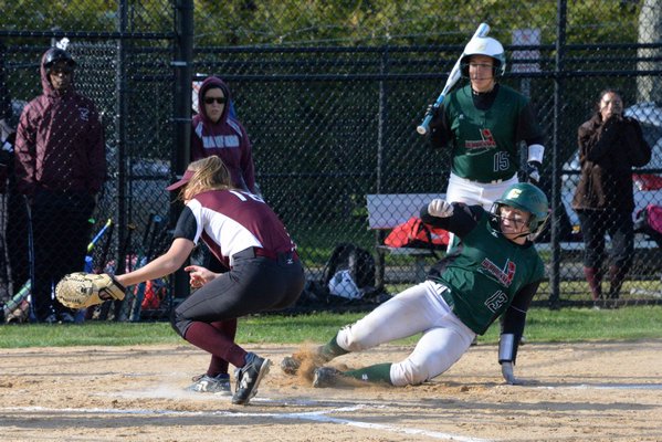 Westhampton Beach junior Lauren Ramos slides safely across home plate on a passed ball. MICHELLE MALONE