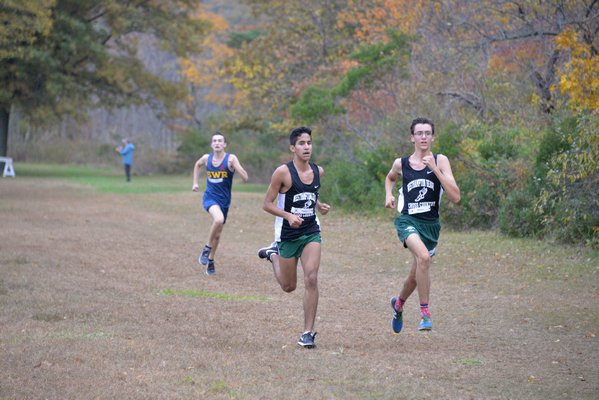 Juan Lasso and Gavin Ehlers head toward the finish line together. Their fifth and sixth overall placements helped the Hurricanes win the Suffolk County Class B title. MICHELLE MALONE