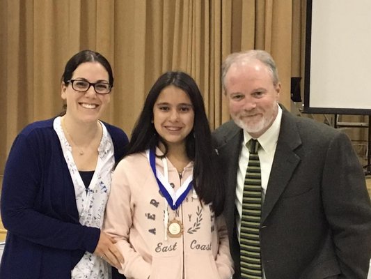 PTA Vice President Amanda Moran, PTA Student of the Month Award winner, Valentina Zarama, Superintendent/Principal Robert Long.