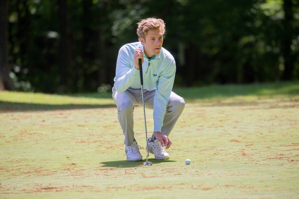 East Hampton senior Turner Foster lines up a shot at the New York State Boys Golf Championships, which were held June 1-3. PATRICK SHANAHAN