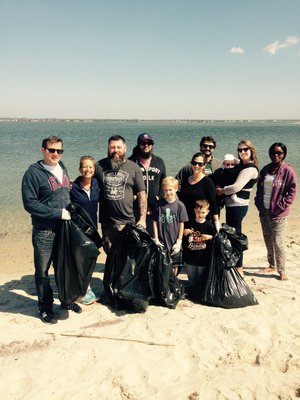 Volunteers, including Councilwoman Christine Scalera, second from left, and Westhampton Beach Village Trustee Candidate Brian Tymann, third from left, cleaned up Pikes Beach in West Hampton Dunes Village during the Great East End Cleanup. COURTESY SOUTHAMPTON TOWN