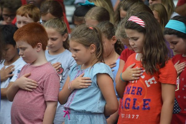 Students at Remsenburg-Speonk Elementary School dressed in red, white and blue sing The Star Spangled Banner to help break a Guinness World Record. AMANDA BERNOCCO