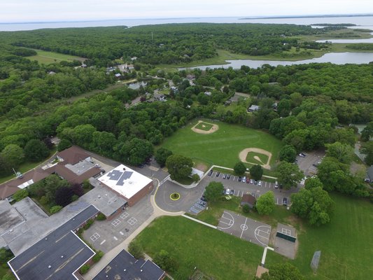 An overhead view of the existing Springs School building. If the proposed plans were enacted, the building would connect with the addition of a new gym and seven classrooms, creating a continuous,  figure eight structure. A new parking system with a drop-off only section would also be added in an attempt to expedite the flow of traffic.