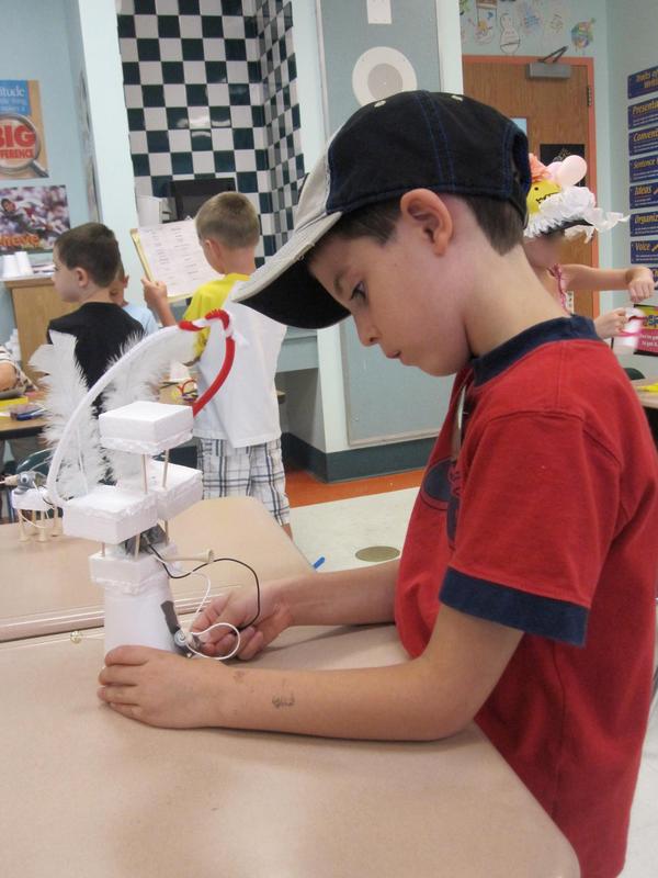 A student at the Riley Avenue Elementary School Camp Invention program invents his own machine.