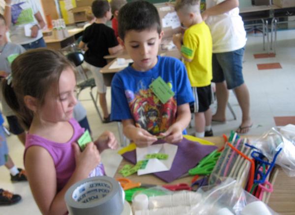 Kids work in groups to create solutions at the Riley Avenue Elementary School Camp Invention program.