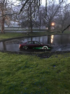 Five men in a Hyundai Sonata missed the turn from Woods Lane to Main Street in East Hampton and drove into Town Pond early Saturday morning at 4:45 AM East Hampton Village Police Chief Michael Tracey said. COURTESY STEVEN SHEADES.