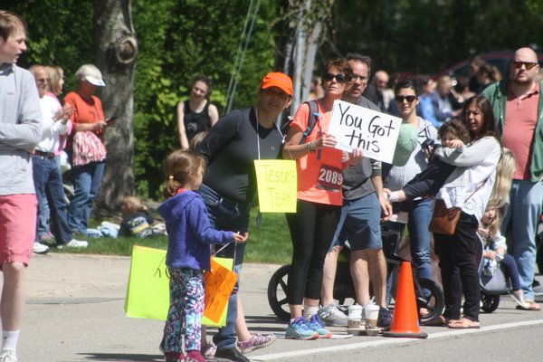 Spectators cheer on the runners as they approach the finish line.   CAILIN RILEY