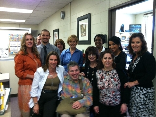 Harry Lewis, center, poses with colleagues at the Suffolk Community College in Northampton. MARY REESE