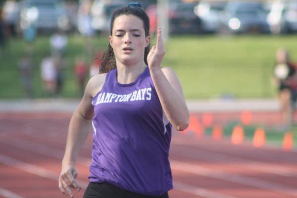 Rachel Reycroft in the 200-meter dash at the state qualifier at Comsewogue High School on Friday and Saturday. CAILIN RILEY