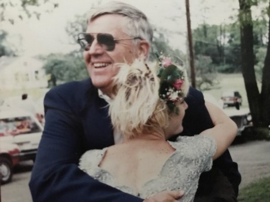 Cliff Foster hugs his daughter, Marilee Foster, after her graduation from East Hampton High School.