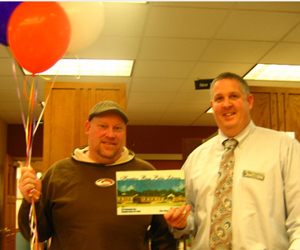 The Hampton Bays Public Library lent out its 4 millionth item on the morning of Thursday, March 4. Above, the lucky patron, Larry Haines, 37, of Hampton Bays, poses with Michael Firestone, the library's director.