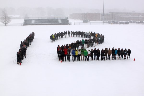 Students, alumni, family and friends of Cory Hubbard gathered on Carl Hansen Memorial Field to form the number 12, the number Cory wore while playing football and lacrosse at Westhampton Beach High School. Neil Salvaggio