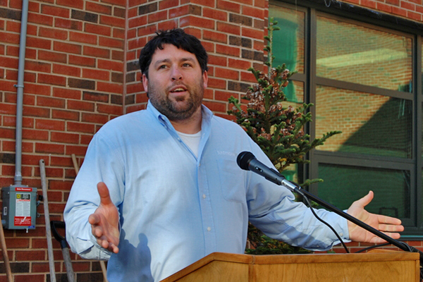 Brian Tymann, Director of Operations at SunStream USA, addresses students in Westhampton Beach High School's courtyard.