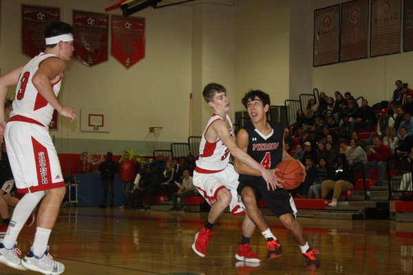 Peter Schaefer drives to the hoop in Pierson's loss to Southold. CAILIN RILEY