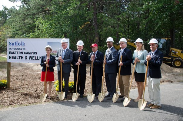 Sarah Anker, Richard O'Kane, Thomas Barraga, Kenneth LaValle, Gordon Canary, Fred Thiele, Jr., Bridget Fleming, and Jay Schneiderman attend the groundbreaking ceremony for the new Suffolk County Community College Eastern Campus Health and Wellness Center on Monday. GREG WEHNER