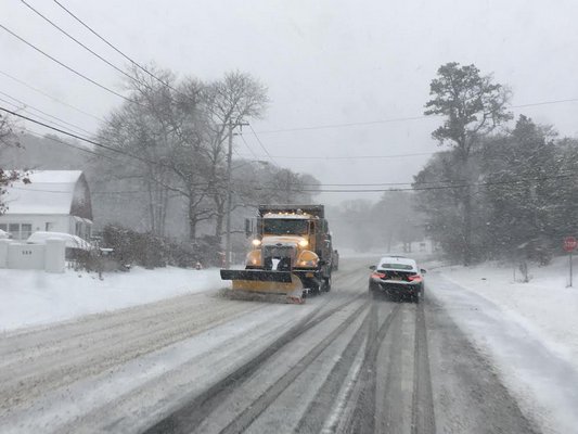 Plows clear Montauk Highway in Hampton Bays during Saturday's snow storm.