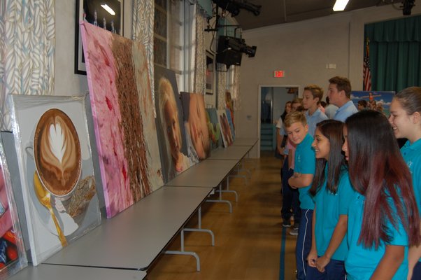 Students of Our Lady of the Hampton Regional Catholic School looking at paintings of artist Charles Wildbank. JON WINKLER